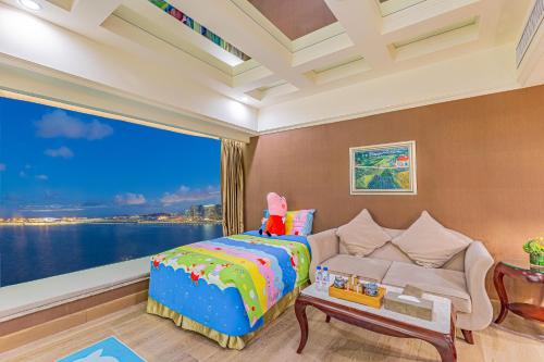 a bedroom with a bed and a large window at Grand Bay Hotel Zhuhai in Zhuhai