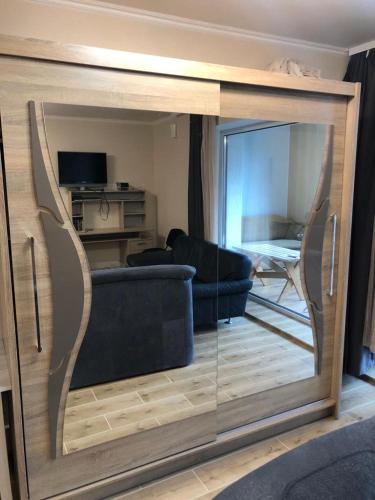 a living room with a couch and a mirror at Appartament Karja 26A/10 in Narva-Jõesuu