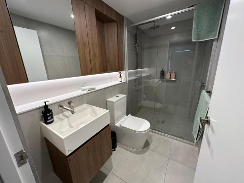 a bathroom with a sink and a toilet and a shower at Rise to the top! in Melbourne