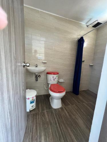 a small bathroom with a toilet and a sink at poblado canela in Melgar