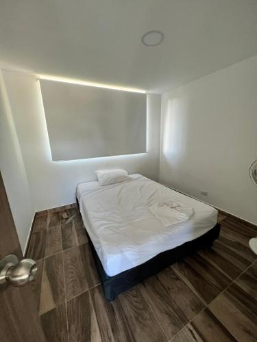 a small bedroom with a bed in a room at poblado canela in Melgar