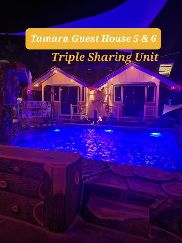a house with a swimming pool at night at TAMARA GUEST HOUSE in Tioman Island