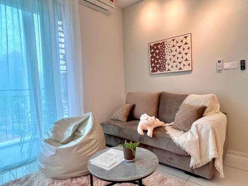 a living room with a couch and a table at 2-8pax Ipoh Nomado Onsen suites by Sunway Onsen Lost world of Tambun in Ipoh