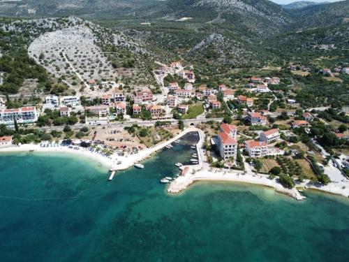 an aerial view of a resort near the ocean at Apartments Nina - private parking in Seget Vranjica