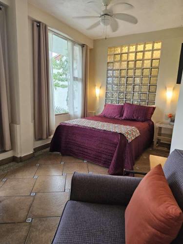 a bedroom with a bed and a couch at Casa Cielo in Valle de Bravo