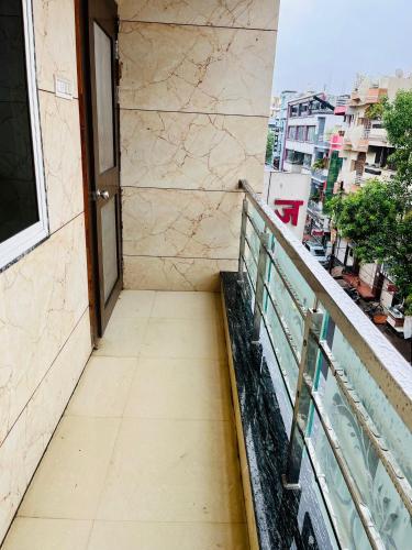 a stairway leading to a balcony with a door at Bansiwala Homestay in Ujjain