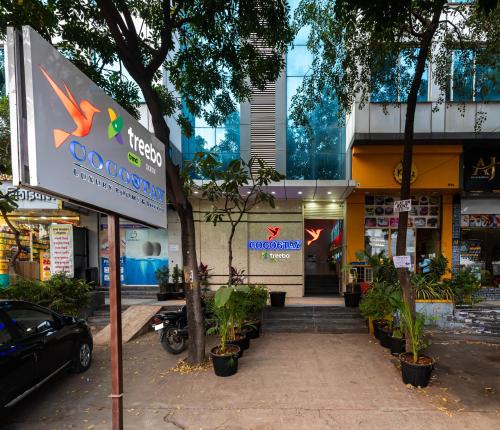 a store with a sign in front of a building at Treebo Trend Cocostay in Pune