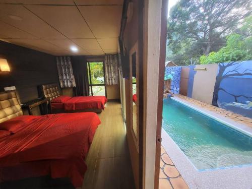a room with a swimming pool and two beds at Tamara Private Pool in Tioman Island