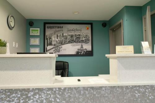 a lobby with blue walls and a picture on the wall at Super 8 by Wyndham Rockford I-90 Casino District in Rockford