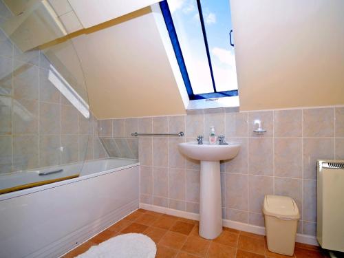 a bathroom with a sink and a skylight at Arthfan in Llanelltyd