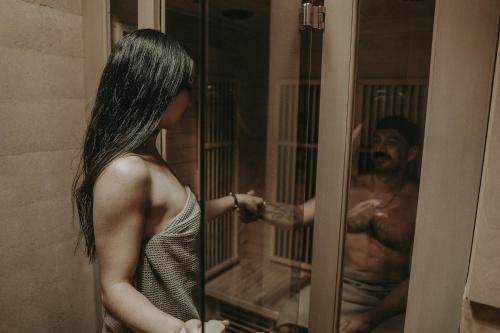 a woman looking at a man in a mirror at MIRA Earth Studios in Valle de Guadalupe