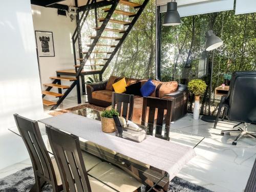 salon z kanapą i stołem w obiekcie Peaceful & Contemporary Duplex Escape w mieście Ban Thap Nang