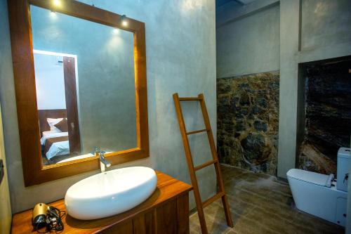 a bathroom with a sink and a mirror at The Shades Galle in Galle