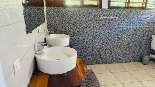 a bathroom with two sinks and a toilet in it at Villa Lavany in Nosy Be