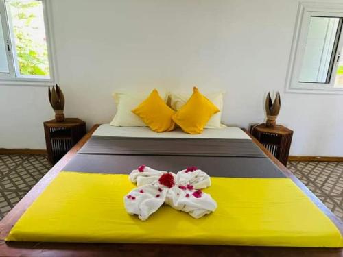 a bedroom with a bed with towels on it at Villa Lavany in Nosy Be