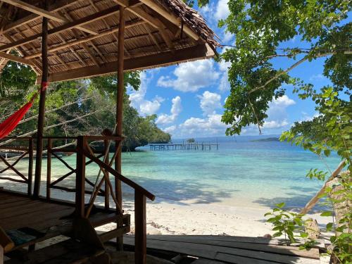 a view of a beach with a pier in the water at I&D Home Stay Raja Ampat in Yennanas Besir