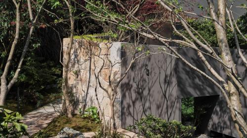 a concrete structure with trees in front of it at Yakamoz Qianchuan Hotel in Lin'an