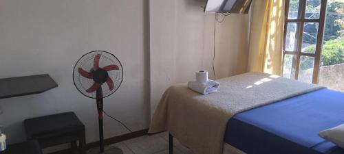 a room with a bed and a fan at Safety and Comfort in Santa Cruz de la Sierra