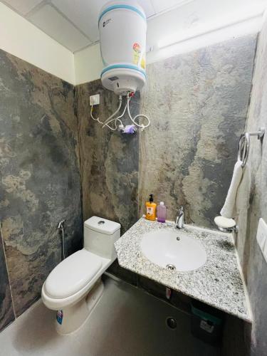 a bathroom with a toilet and a sink at ALanKrita Homes in Lucknow