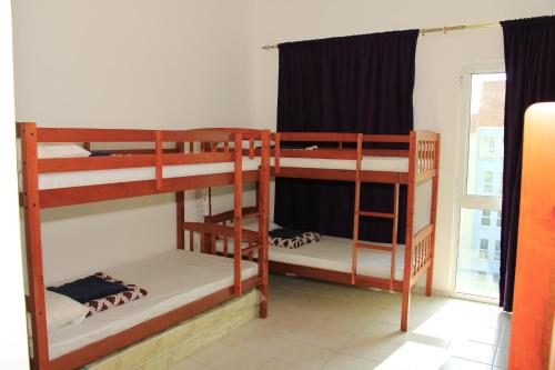 two bunk beds in a room with a window at Dreams Hostel in Dubai