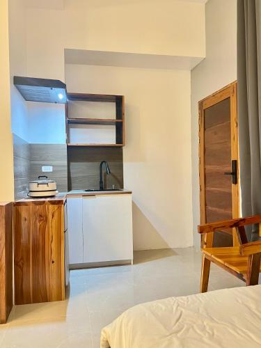 a room with a kitchen with a sink and a counter at Tranquil Villa - Studio Room with Kitchenette in General Luna