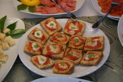 a plate of food with toast with tomatoes on it at Residence Aprilia in Grado