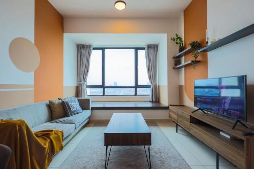 a living room with a couch and a tv at Greenfield Residence, Bandar Sunway by The Comfort Zone in Petaling Jaya