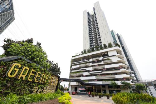 a tall building with a sign in front of it at Greenfield Residence, Bandar Sunway by The Comfort Zone in Petaling Jaya