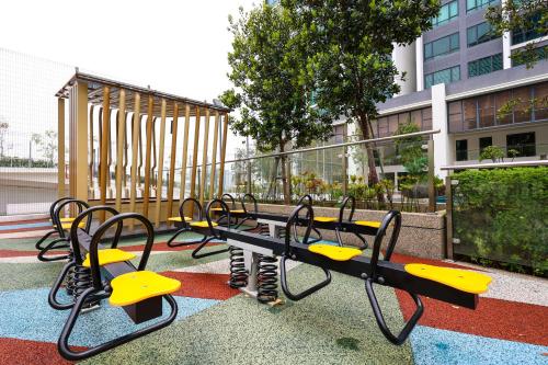 a group of benches sitting in front of a building at Greenfield Residence, Bandar Sunway by The Comfort Zone in Petaling Jaya