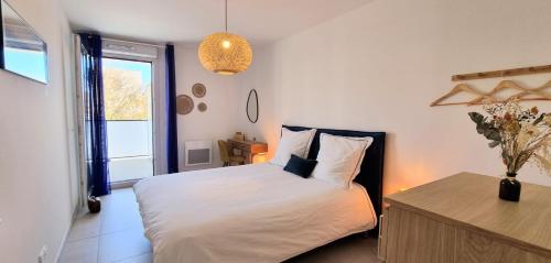 une chambre avec un lit, une table et une fenêtre dans l'établissement LE SEGRETO Déco Sur les quais 2 Parkings Privés Neuf, à Sète