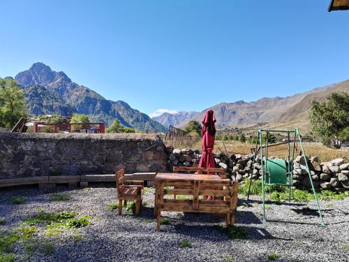 a playground with a table and a swing at Cottage Shina in Kazbegi