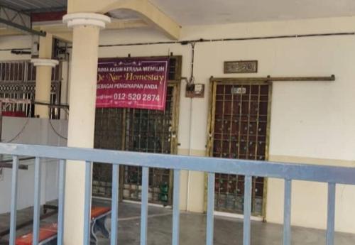 a building with a gate and a sign on it at DENAR HOMESTAY CHANGLUN KEDAH in Changlun