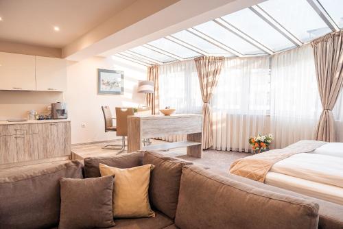 a living room with a couch and a bed at Cityscape Luxury Suites in Plovdiv