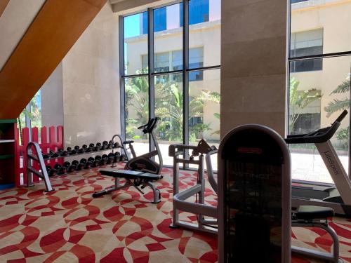 a gym with cardio equipment in a building at Muong Thanh Luxury Nhat Le Hotel in Dong Hoi