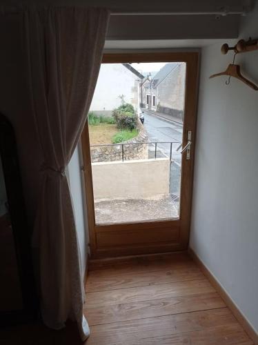 an open door with a window in a room at Maison vue sur Cher in Bruère-Allichamps