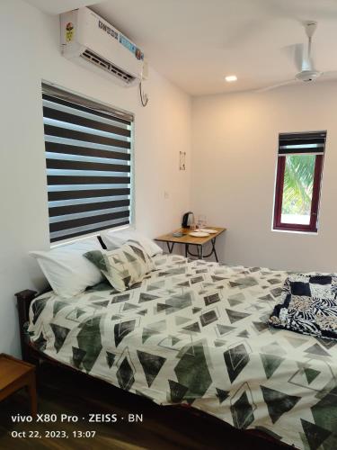 a bedroom with a bed and a window at Sunshine Service Villa in Kannur