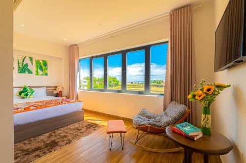 a bedroom with a bed and a large window at HA Gateway Inn Hoian Priavate Pool Villa in Hoi An