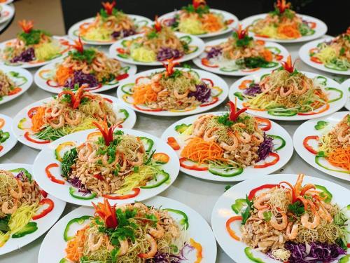 a group of plates of food on a table at Muong Thanh Luxury Nhat Le Hotel in Dong Hoi