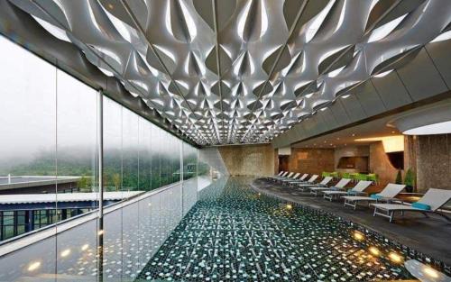 a hotel lobby with a pool of water on the floor at Hilltop Cloud View Genting Luxury Suite in Genting Highlands