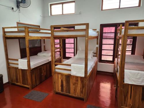 a group of bunk beds in a room with windows at CEYLON STAYZ in Colombo