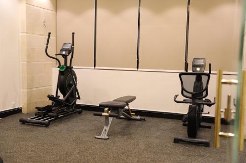 a gym with three exercise bikes and weights at فندق جولدن إيليت - Golden Elite Hotel in Al Khobar