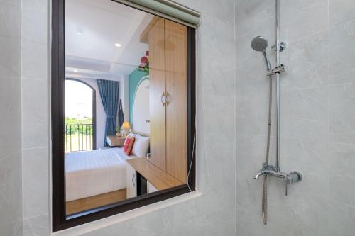 - Baño con espejo y dormitorio en Gold Holiday Hotel en Vung Tau