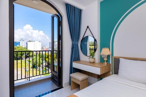 a bedroom with a bed and a window with a view at Gold Holiday Hotel in Vung Tau