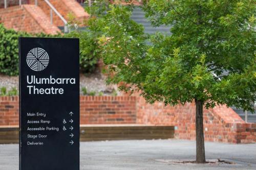 a sign next to a tree in front of a building at COSY RETREAT ON FOREST --- Offering 3 Comfortable Bedrooms - Sleeps Up to 6 - Please Note - If Booking for 5 or more guests all 3 rooms will be required in Bendigo