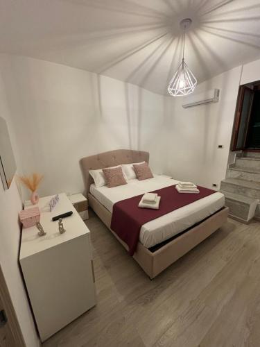 una camera con un grande letto e un comodino con un letto sidx sidx. di MERGELLINA APARTMENT a Napoli