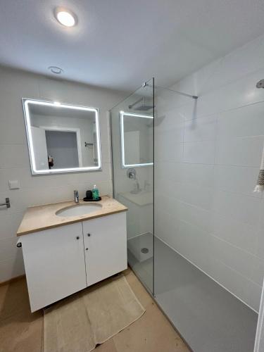 a bathroom with a shower and a sink and a mirror at Lido Casa by Olá Madeira in Funchal