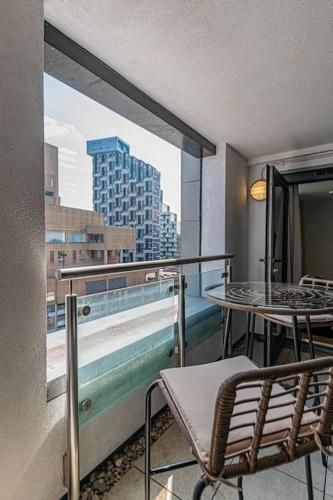a balcony with a table and chairs and a view of a city at 1 Bed Apt - Balcony - City View - Great Location in Liverpool