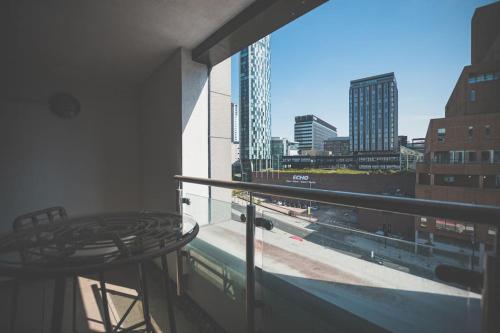 a balcony with a table and a view of a city at Luxurious 1 Bed - CITY VIEW in Liverpool