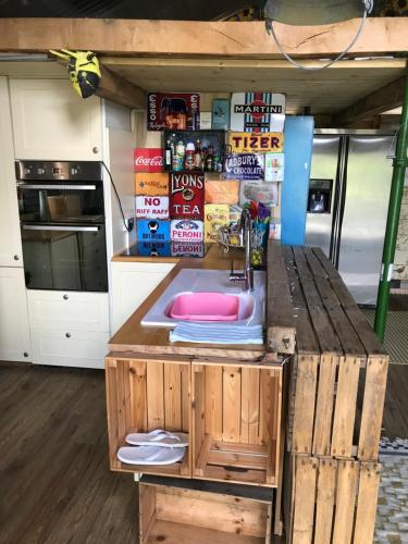 a kitchen with a wooden counter with a sink at Prestwick Oak - Sleeps 10-14 - Group Accommodation for Family or Friends in Haslemere