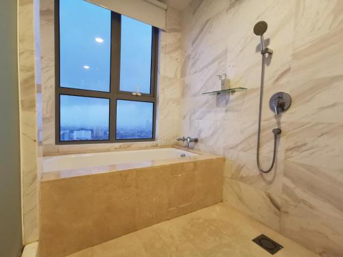 a bathroom with a bath tub and a window at Attic Home Melaka Silverscape Residence & Jonker in Malacca